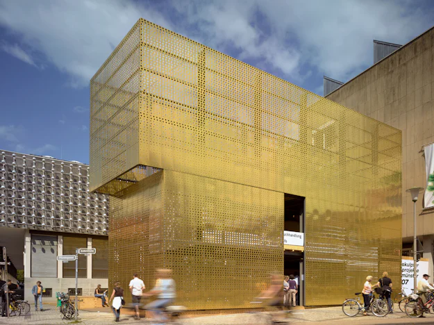 Perforated Façades: 7 Buildings Cloaked in Metal Mesh Panels ...